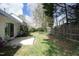 Grassy backyard features a patio and a wooden fence, complemented by mature trees at 5513 Edgebury Rd, Raleigh, NC 27613