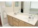 Bathroom featuring double sinks with wooden cabinets at 5513 Edgebury Rd, Raleigh, NC 27613