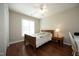 Bright bedroom with a wood-framed bed, ceiling fan and light, and hardwood floors for a cozy, inviting space at 5513 Edgebury Rd, Raleigh, NC 27613