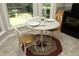 Cozy breakfast nook featuring a round table, two chairs, and natural light from the surrounding windows at 5513 Edgebury Rd, Raleigh, NC 27613