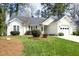 Charming one-story home featuring a well-manicured lawn, mature shrubs, and an attached garage, presenting great curb appeal at 5513 Edgebury Rd, Raleigh, NC 27613