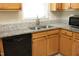Kitchen counter with granite countertops, stainless steel sink, and black dishwasher at 5513 Edgebury Rd, Raleigh, NC 27613
