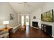 Bright living room with vaulted ceilings, cozy fireplace, hardwood floors and sliding glass doors for natural light at 5513 Edgebury Rd, Raleigh, NC 27613