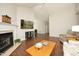 Open-concept living room with fireplace, hardwood floors and bright light at 5513 Edgebury Rd, Raleigh, NC 27613