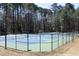 Outdoor tennis courts surrounded by tall trees, fenced in, and lit for evening play at 5513 Edgebury Rd, Raleigh, NC 27613