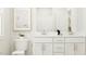 Bright, modern bathroom with a dual sink vanity, white cabinets, and stylish fixtures at 712 Swim Cave Ln, Wendell, NC 27591