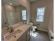 Bathroom with double sink vanity, large mirror and plenty of natural light from two windows at 712 Swim Cave Ln, Wendell, NC 27591