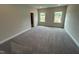 Bright bedroom with two windows, carpet flooring, and neutral walls providing a serene retreat at 712 Swim Cave Ln, Wendell, NC 27591