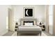 Serene bedroom with a plush grey bed, matching side tables, and soft natural light from the window at 712 Swim Cave Ln, Wendell, NC 27591