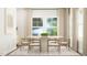 Bright dining room with a round table, neutral chairs, and soft, natural light at 712 Swim Cave Ln, Wendell, NC 27591