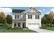 Charming two-story home featuring gray shutters, a welcoming front porch, and a two-car garage at 712 Swim Cave Ln, Wendell, NC 27591