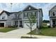Inviting exterior view of a well-maintained two-story home with a two-car garage and nice lawn at 712 Swim Cave Ln, Wendell, NC 27591