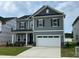 Beautiful two-story home featuring a spacious two-car garage and neutral gray siding at 712 Swim Cave Ln, Wendell, NC 27591