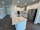 Modern kitchen featuring white cabinets, stainless steel appliances, and a stylish island at 712 Swim Cave Ln, Wendell, NC 27591