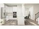 Bright kitchen with white cabinets, stainless steel appliances, and a kitchen island with seating at 712 Swim Cave Ln, Wendell, NC 27591