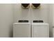 Functional laundry room equipped with a modern washer and dryer for convenient chores at 712 Swim Cave Ln, Wendell, NC 27591