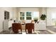 Cozy living room features a white sofa, two rust-colored chairs, and a large window for natural light at 712 Swim Cave Ln, Wendell, NC 27591