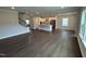 Spacious living area showcasing open floor plan with dark hardwood flooring and white kitchen at 712 Swim Cave Ln, Wendell, NC 27591
