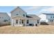 Exterior view of a home with a covered patio and a spacious backyard offering outdoor living at 724 Summer Music Ln, Raleigh, NC 27603