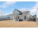 View of the backyard with a covered patio, grill and view of the home's exterior at 724 Summer Music Ln, Raleigh, NC 27603