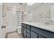 Bathroom with dual sinks, modern vanity, and a shower/tub combo with a blue and white shower curtain at 724 Summer Music Ln, Raleigh, NC 27603