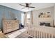 Charming Bedroom featuring a crib, dresser, and decor for a cozy and inviting space at 724 Summer Music Ln, Raleigh, NC 27603