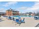 Community pool with lounge chairs and tables under a clear, sunny sky at 724 Summer Music Ln, Raleigh, NC 27603