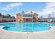 Large community pool with a brick clubhouse and plenty of seating at 724 Summer Music Ln, Raleigh, NC 27603
