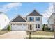 Charming two-story home featuring a two-car garage, neutral siding, and a welcoming front door at 724 Summer Music Ln, Raleigh, NC 27603