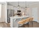 Modern kitchen featuring a quartz island, stainless steel appliances, and pendant lighting at 724 Summer Music Ln, Raleigh, NC 27603
