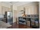 Kitchenette featuring modern appliances, granite countertops, and ample storage space at 724 Summer Music Ln, Raleigh, NC 27603