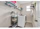 Functional laundry room with shelving, washer, and dryer, providing a clean and organized space at 724 Summer Music Ln, Raleigh, NC 27603