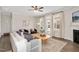 Bright living room featuring a fireplace, ceiling fan, and a glass door for access to the backyard at 724 Summer Music Ln, Raleigh, NC 27603