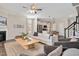 Open-concept living room features a fireplace and seamlessly connects to a modern kitchen with stainless steel appliances at 724 Summer Music Ln, Raleigh, NC 27603