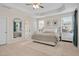 Spacious main bedroom featuring a trey ceiling, ceiling fan, and ensuite bathroom at 724 Summer Music Ln, Raleigh, NC 27603