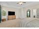 Spacious main bedroom featuring a trey ceiling, ceiling fan, and neutral decor at 724 Summer Music Ln, Raleigh, NC 27603