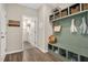 Well-organized mudroom featuring a built-in bench with storage and hooks at 724 Summer Music Ln, Raleigh, NC 27603