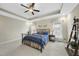 The primary bedroom has carpet flooring, neutral walls, tray ceiling, and natural light from the windows at 73 Vibernum Vw, Four Oaks, NC 27524