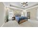 Primary bedroom with tray ceilings, neutral walls, carpet flooring, and natural light from two windows at 73 Vibernum Vw, Four Oaks, NC 27524