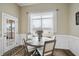 Bright breakfast nook featuring wood flooring, a round table with four chairs, and views of the beautiful outdoors at 73 Vibernum Vw, Four Oaks, NC 27524