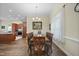 This is a dining room with wood floors, wooden table with six chairs, and natural light from the window at 73 Vibernum Vw, Four Oaks, NC 27524