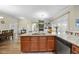 Open kitchen featuring stainless steel appliances, granite countertop island, and an open view to the living room at 73 Vibernum Vw, Four Oaks, NC 27524