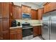 This is a kitchen featuring stainless steel appliances, tile backsplash, wood cabinets, and granite countertops at 73 Vibernum Vw, Four Oaks, NC 27524