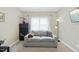 Comfortable living room featuring a plush couch, storage shelf, window, and a lamp creating a cozy space at 73 Vibernum Vw, Four Oaks, NC 27524