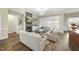 Cozy living room with a stone fireplace, built-in shelving, and modern furnishings at 73 Vibernum Vw, Four Oaks, NC 27524