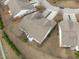 An aerial view displays the townhouse's backyard patios, roof, and surrounding green spaces in a well-maintained community at 734 Hornchurch Loop, Cary, NC 27519
