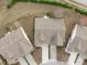 Aerial view showcasing the property's roof, driveway, landscaping, and neighborhood at 734 Hornchurch Loop, Cary, NC 27519