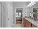 Main bathroom featuring granite counters, double sinks, and access to the main bedroom at 734 Hornchurch Loop, Cary, NC 27519