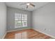 Cozy bedroom with natural light, ceiling fan, and hardwood floors offers a relaxing space at 734 Hornchurch Loop, Cary, NC 27519