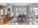 Bright dining area with hardwood floors, table and chairs, and natural light from sliding doors at 734 Hornchurch Loop, Cary, NC 27519